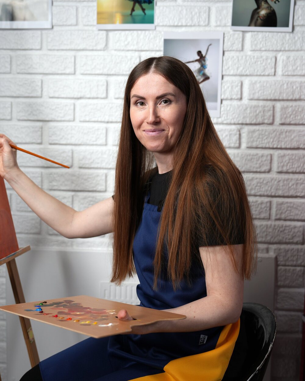 Oksana Buhaiova at her easel in her London studio